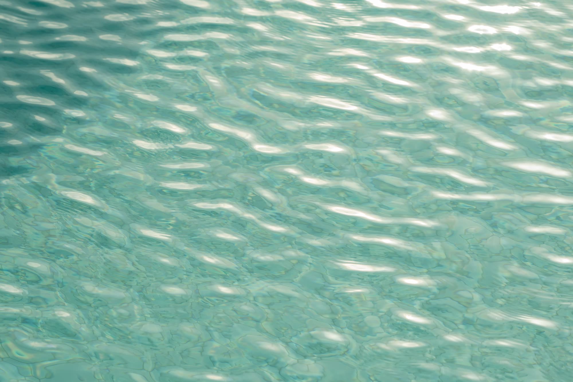 Sunlight on rippled turquoise water